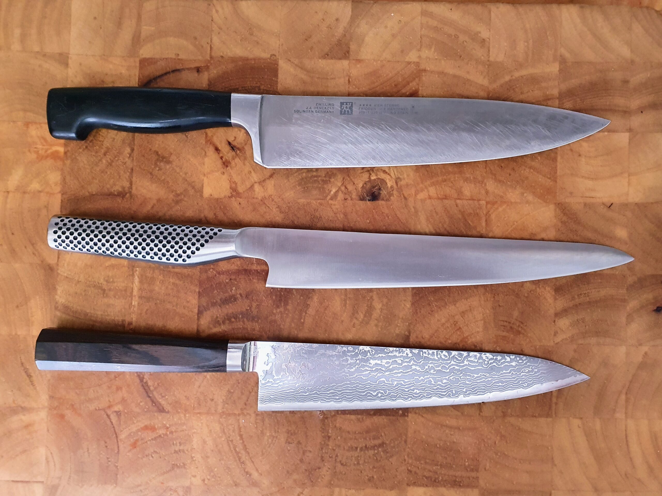 Chef knives on a wooden cutting board